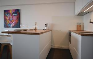 a kitchen with a counter with wine glasses on it at Residence Puerto Cristo R101 in Ostend