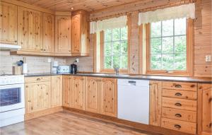 a kitchen with wooden cabinets and white appliances at Eikhaugen Gjestegard in Vinnes