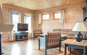 a living room with a couch and a tv at Eikhaugen Gjestegard in Vinnes