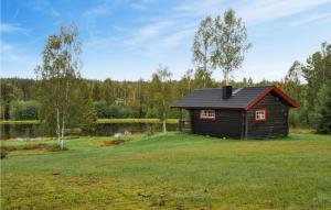 a small cabin in a field of green grass at 2 Bedroom Beautiful Home In Sunne in Sunne