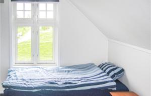 a bed in a room with a window at 4 Bedroom Stunning Home In Rong in Rong