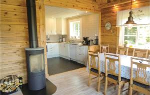 a kitchen and dining room with a wood stove at Stunning Home In Huskvarna With Kitchen in Huskvarna