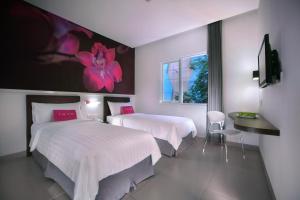 Säng eller sängar i ett rum på favehotel Melawai