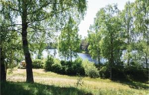 a view of a river from a field with trees at Gorgeous Home In Ambjörnarp With Wifi in Ambjörnarp