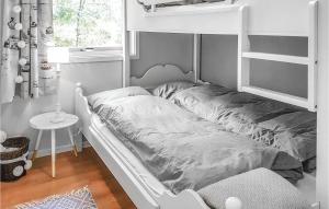 a bed in a bedroom with a bunk bed at Gorgeous Home In Vikanes With Kitchen in Eikemo