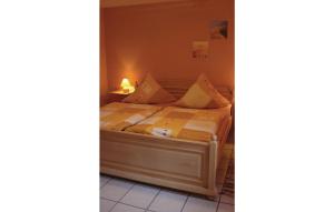 a small bedroom with a bed with a lamp on it at Nice Apartment In Brilon-madfeld With 3 Bedrooms And Wifi in Madfeld