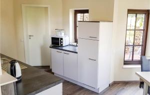 a kitchen with a white refrigerator and a microwave at Awesome Apartment In Brilon-Madfeld in Madfeld
