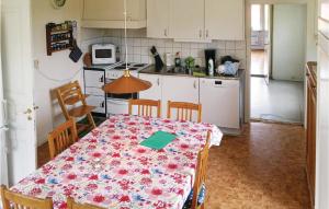 a kitchen with a table with a table cloth on it at 2 Bedroom Pet Friendly Home In Vimmerby in Vimmerby
