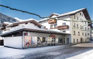 a building with a store in the snow at Ferienwohnung In Rauris in Rauris