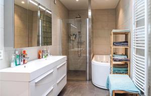 a bathroom with a sink and a tub and a shower at Awesome Apartment In Bokn With Sauna in Kro