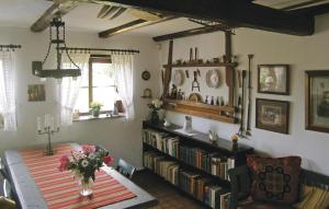 a room with a table and a book shelf with books at Lindersgården in Staffanstorp +15 photos