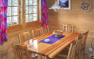 a dining room with a wooden table and chairs at Glomnes Nr 2 in Hjelle