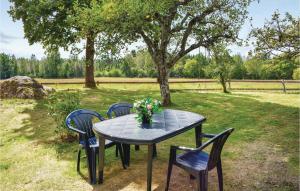 a table with chairs and a vase of flowers on it at 3 Bedroom Stunning Home In Mariannelund in Mariannelund