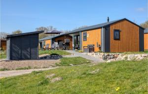 a home with a black and orange building at Cozy Home In Ssel With House A Panoramic View in Süsel