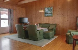 a living room with a table and chairs and a television at Lovely Home In Vestsida With Wifi in Hov