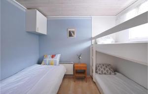 フェリェスターデンにある2 Bedroom Beautiful Home In Frjestadenの青い壁の小さなベッドルーム1室(ベッド2台付)