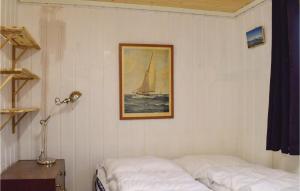 a bedroom with two beds and a picture of a sailboat at Nice Home In Staubø With House Sea View in Staubø +5 photos