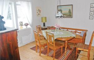 a dining room with a table and chairs at Cozy Home In Ölsremma With Wifi in Ljungsarp