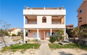 an old house with a balcony on top of it at Nice Apartment In Cres With Wifi in Cres