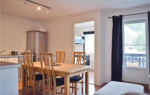 a kitchen and dining room with a wooden table and chairs at Gorgeous Apartment In Uvdal With Wifi in Uvdal