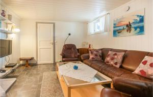 a living room with a couch and a coffee table at Awesome Apartment In Rros With 3 Bedrooms And Wifi in Røros