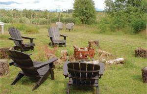 a group of chairs sitting in the grass at 3 Bedroom Awesome Home In Mårdaklev in Mårdaklev +25 photos