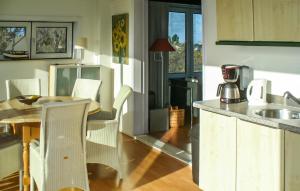 a kitchen with a table and chairs and a kitchen with a sink at Bellevue in Bergen aan Zee