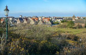 a city with a street light in the foreground at Bellevue in Bergen aan Zee