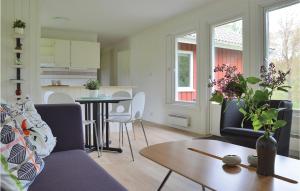 a living room with a couch and a table at Nice Home In Vaggeryd With 2 Bedrooms And Sauna in Hok