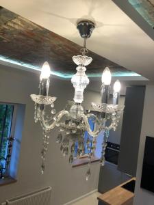 a chandelier hanging from a ceiling at Old Town Deluxe Apartment in Klaipėda