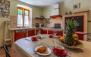 a kitchen with a table with a pineapple on it at Nice Home In Medulin With Wifi in Medulin