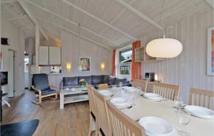 a dining room and living room with a table and chairs at Abendrot 2 - Dorf 3 in Priwall