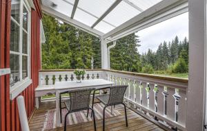 a screened porch with a white table and chairs at Three-Bedroom Holiday Home In Arjang in Smolmark
