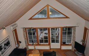 a living room with a large window in the attic at 5 Bedroom Awesome Home In Segmon in Kangerud