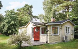 a small yellow house with a red door at 3 Bedroom Nice Home In Beddingestrand in Beddinge Strand