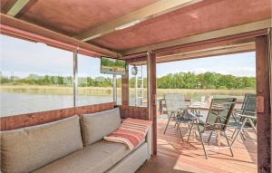 a living room with a couch and a screened in porch at Awesome Ship In Radewege With Kitchen in Radewege