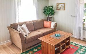 a living room with a couch and a coffee table at 2 Bedroom Amazing Home In Unnaryd in Unnaryd