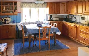 a kitchen with a table and chairs and a table and a window at Amazing home in Unnaryd with 2 Bedrooms, Sauna and WiFi in Unnaryd