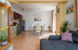 a living room and kitchen with a couch and a table at Holiday Home Dobrani Cr in Rebići