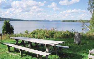 a picnic table with a view of a lake at Amazing Home In Hagfors in Hagfors
