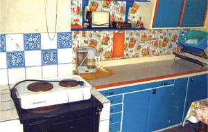 a kitchen with a stove and blue cabinets at Amazing Home In Hagfors in Hagfors