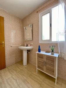 a bathroom with a sink and a mirror at Casa Paty Fuerteventura in Puerto del Rosario +45 photos