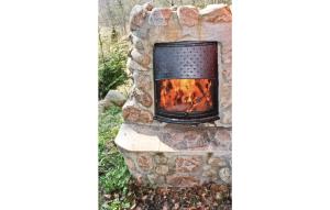 a fireplace made out of a stone at 2 Bedroom Beautiful Home In Örkelljunga in Drakabygget