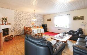 a living room with leather furniture and a table at Holiday Home Skyttevägen Sölvesborg Ii in Hällevik