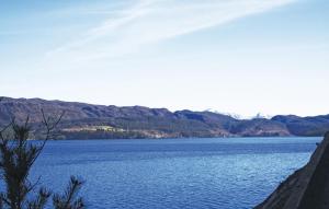 a large body of water with mountains in the background at Beautiful Home In Nordtveitgrend in Haugen