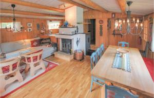 ein Wohnzimmer mit einem Tisch und einem Kamin in der Unterkunft Nice Home In Sjusjen With House A Mountain View in Sjusjøen