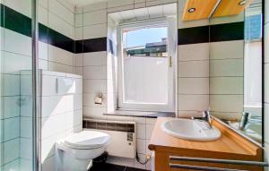 a bathroom with a toilet and a sink and a window at Nadrin O Vert in Nadrin