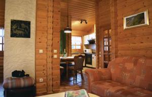 a living room and kitchen in a log cabin at Lovely Home In Bodenfelde With Kitchen in Amelith