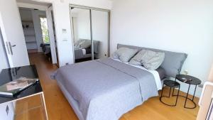 a bedroom with a large bed and a mirror at PORTO BLUE LUXURY APARTMENT in Porto Rafti +32 photos