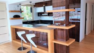 a kitchen with a wooden island in a room at PORTO BLUE LUXURY APARTMENT in Porto Rafti